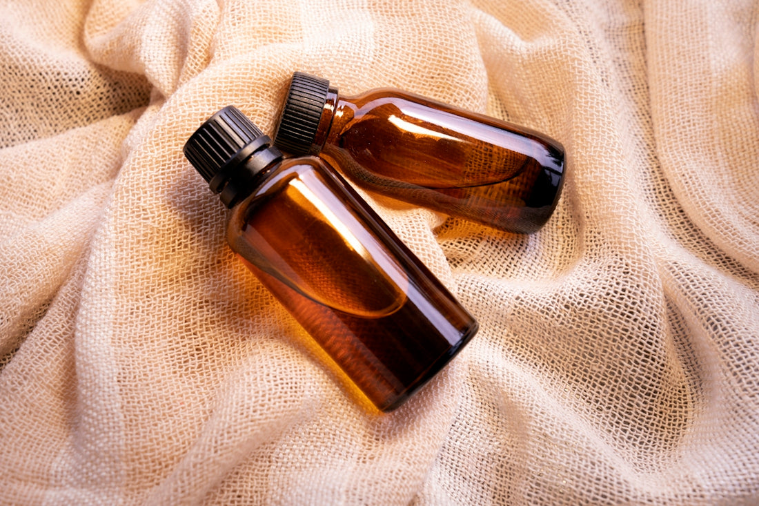 a couple of brown bottles sitting on top of a bed