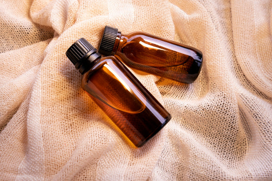 a couple of brown bottles sitting on top of a bed